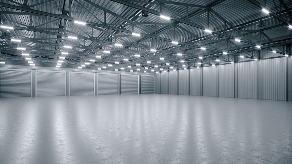 Empty industrial warehouse with bright ceiling lights
