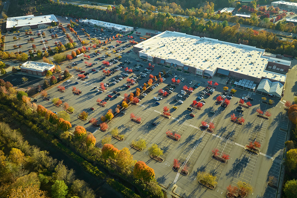 Aerial view of shopping center with empty parking lot