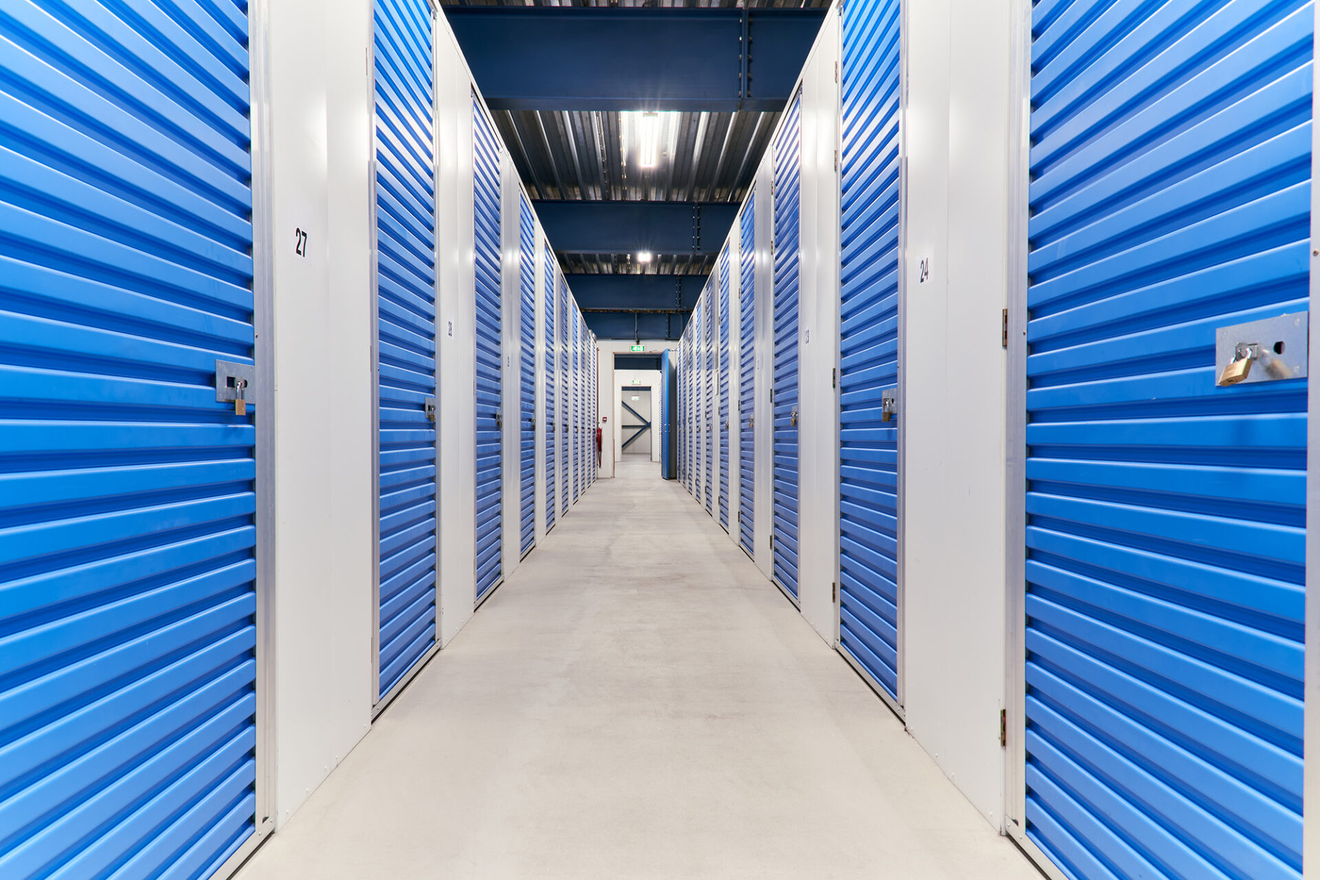 Hallway of blue self-storage unit doors